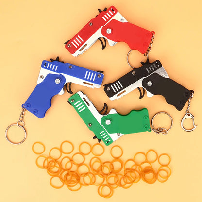 1PC Mini Toy Metal Gun with Rubber Band Fun Folding Pistol Key Charm Pendant Kids Birthday Gifts Toys Boy Girl Game Party Favors